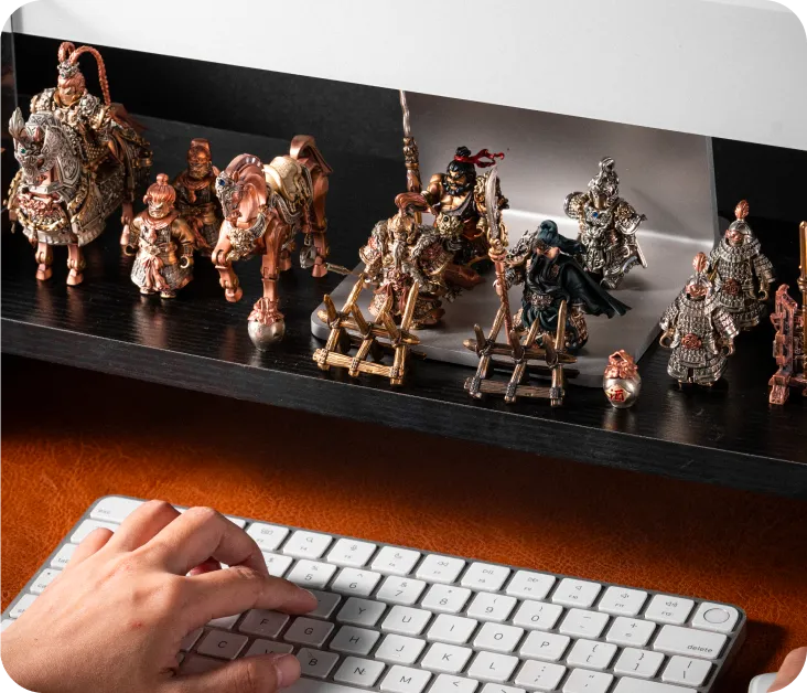 Metal figures displayed on a desk shelf