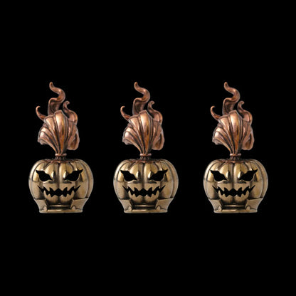 Three pumpkin heads against a black background