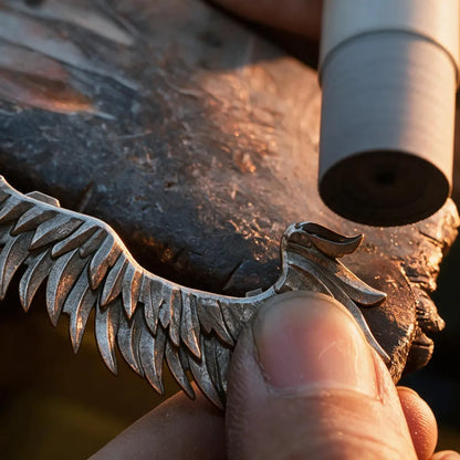 Polishing the sculpted wing of a Winged Hussar magnetic metal figurine