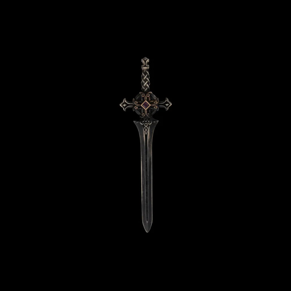 Dark miniature sword with an ornate crossguard on a black background