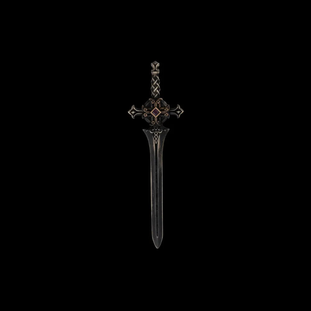 Dark miniature sword with an ornate crossguard on a black background