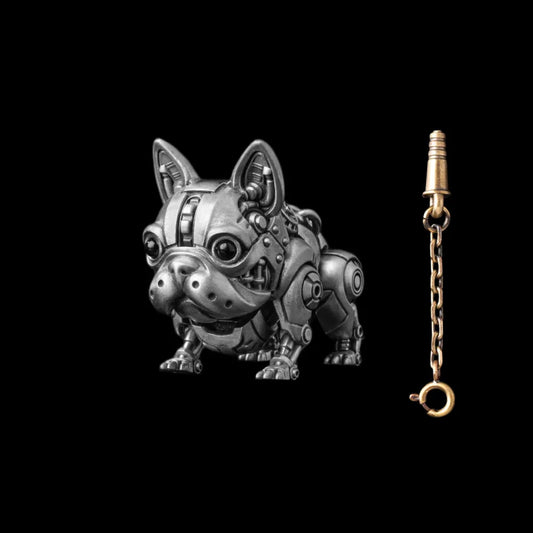 A dark silver-tone mechanical dog figure beside a gold-tone key on a chain.