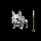A bright silver-tone mechanical dog figure beside a gold-tone key on a chain.
