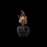 Black pumpkin head with a copper-colored flame plume on a black background