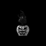 Silver-colored pumpkin head with a dark flame plume on a black background