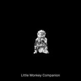 Small monkey companion figure against a black background