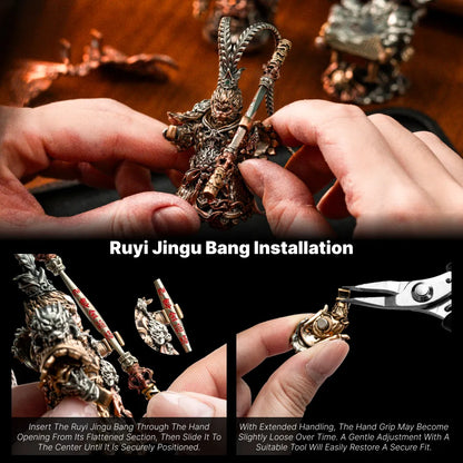 Hands attaching a staff to a Wukong figure